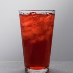 clear drinking glass with brown liquid