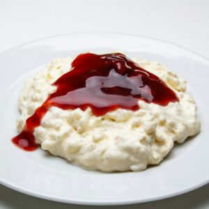 white rice with red sauce on white ceramic plate
