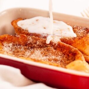 person pouring milk on white ceramic bowl