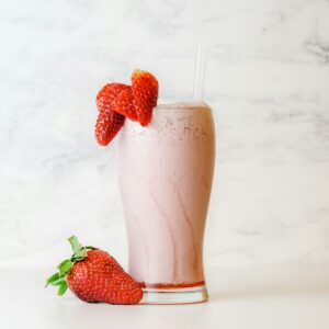 strawberry shake in clear drinking glass