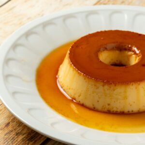 a small dessert on a white plate on a wooden table